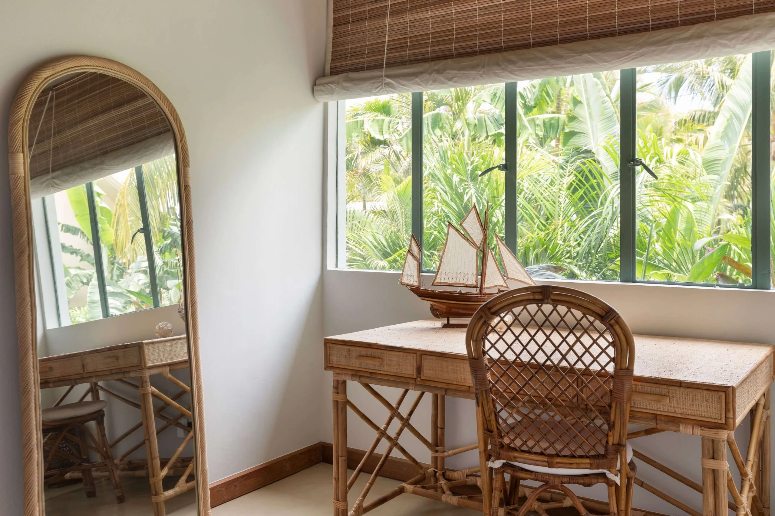 Tropical greenery flows throughout, present indoors and out.