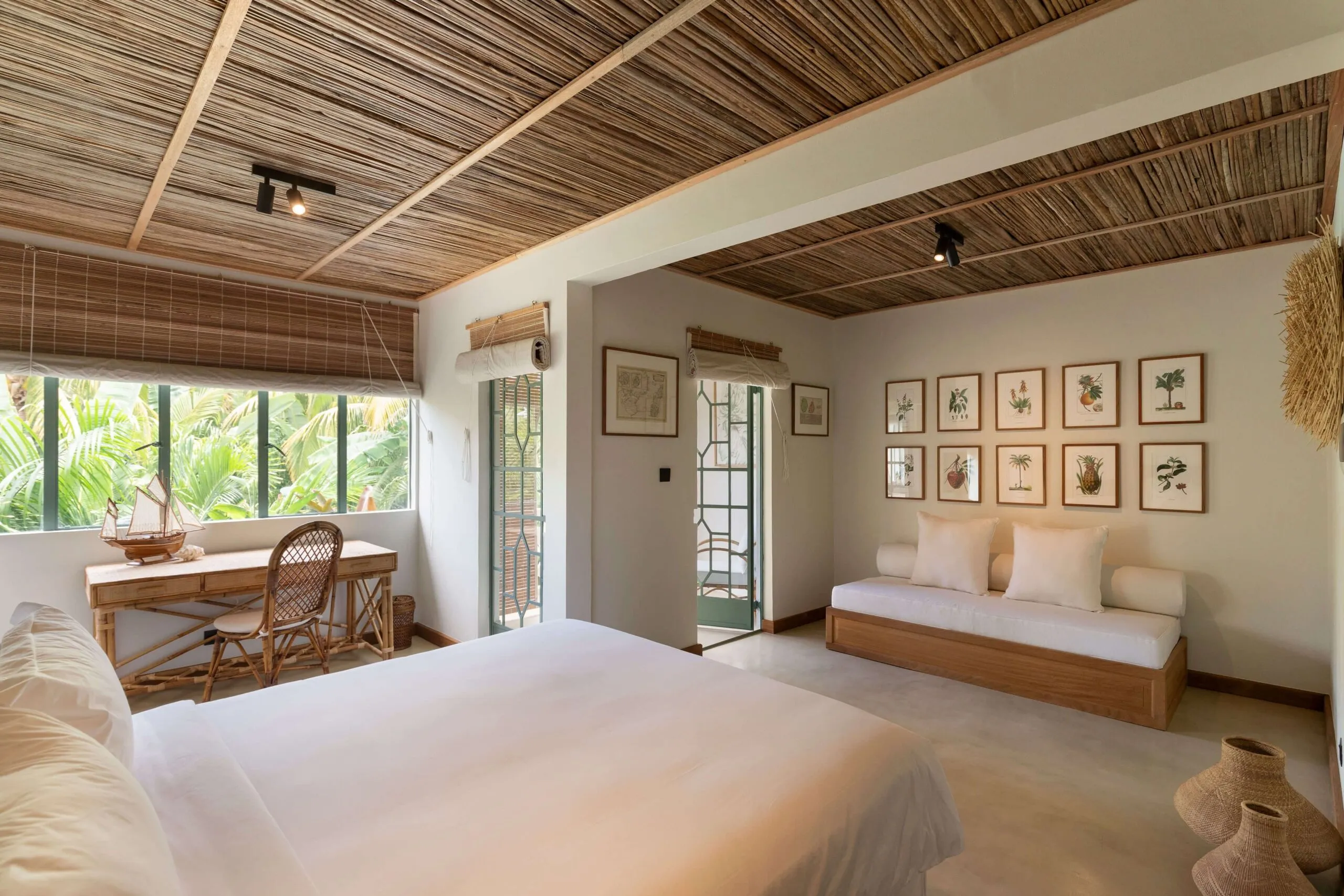 Deluxe suite bedroom, generous in size, with a daybed and desk.