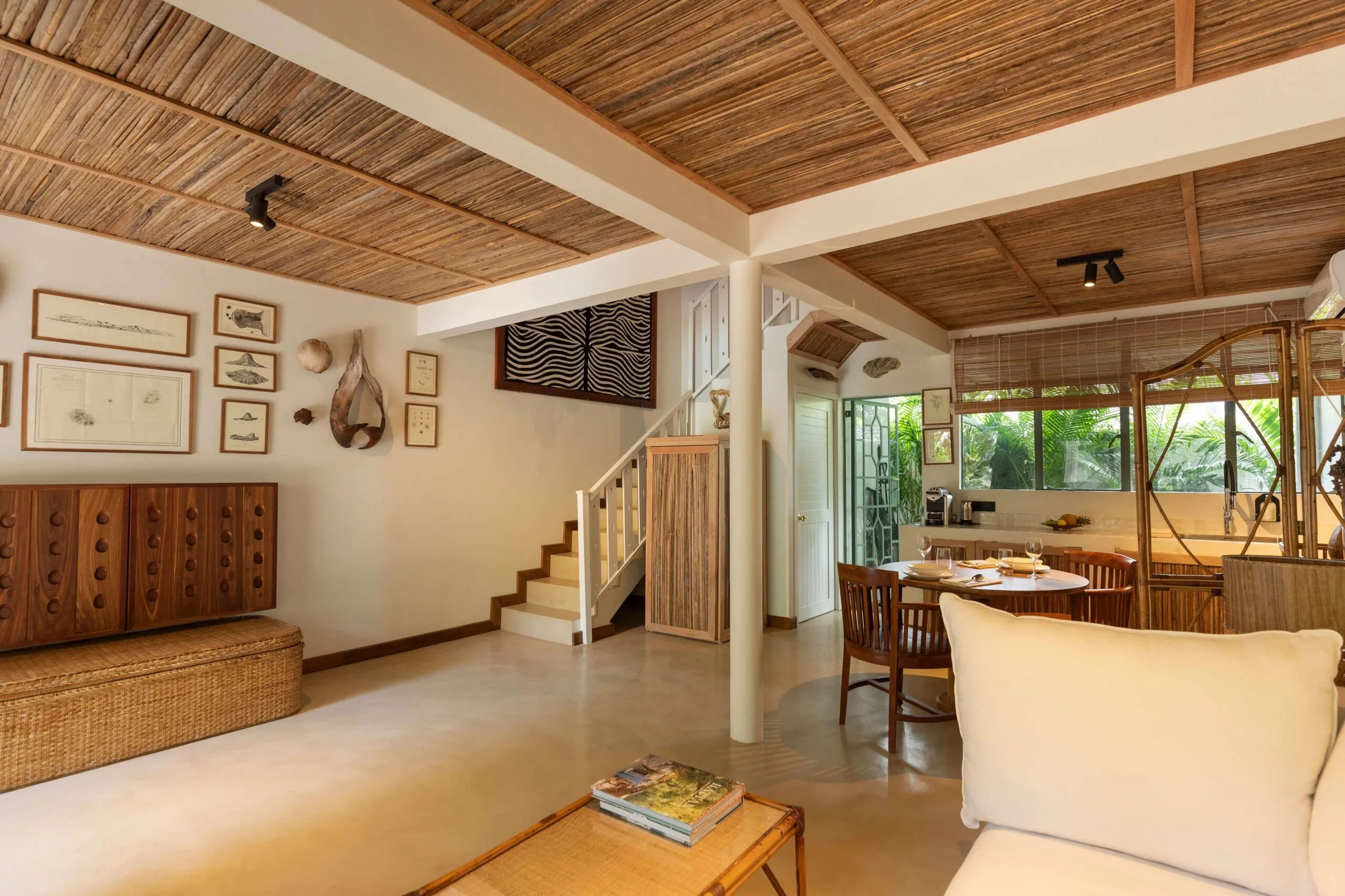 A living area with TV and full-size fridge, discreetly concealed in wood.